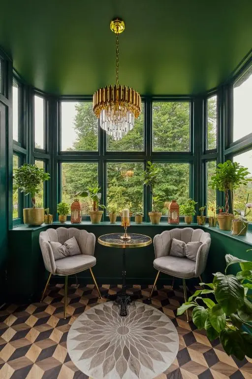 a green room with a table and chairs and windows at Old Manse of Craggan in Glenlivet