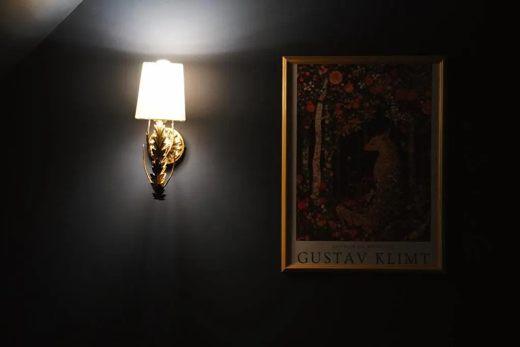 a lamp attached to a wall with a picture at Old Manse of Craggan in Glenlivet
