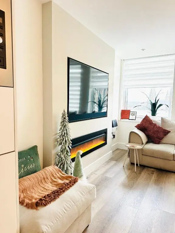a living room with a tv and a couch at St\u0101 by The Bridge, Inverness City Centre in Inverness