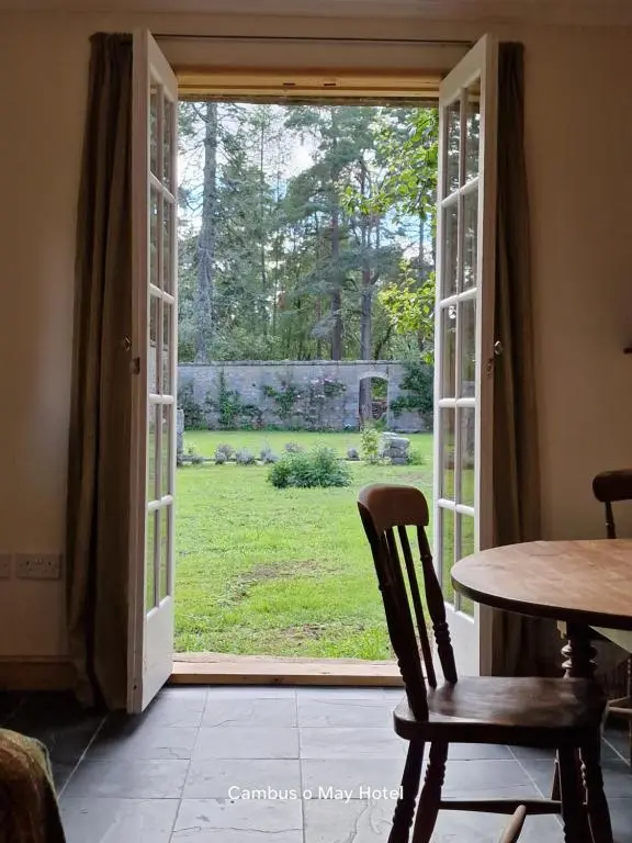 an open door with a view of a yard at Garden Cottage in Cambus O\u02bcMay Station