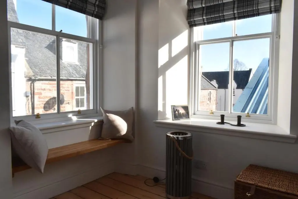 a room with two windows and a radiator at The MacKenzie Apartment in Beauly