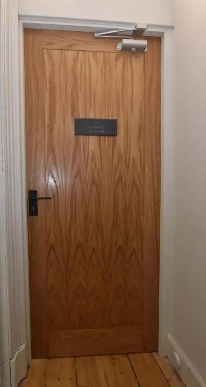 a wooden door with a sign on it at The MacKenzie Apartment in Beauly