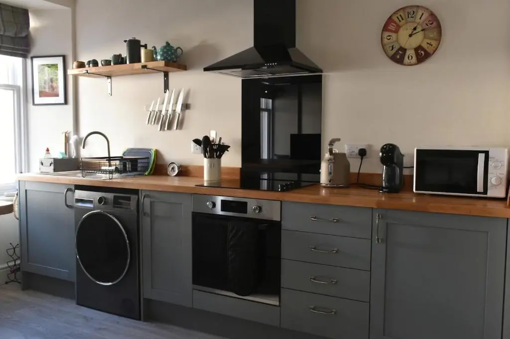 a kitchen with a stove and a microwave at The MacKenzie Apartment in Beauly