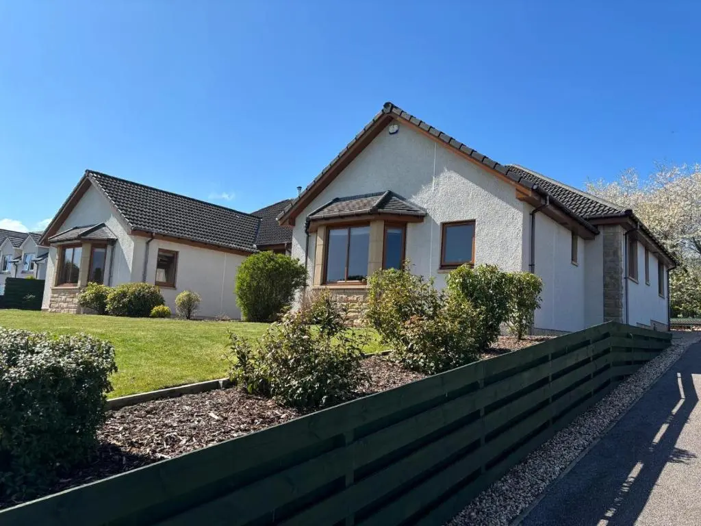 a house with a fence in front of it at Danian B&B in Dingwall