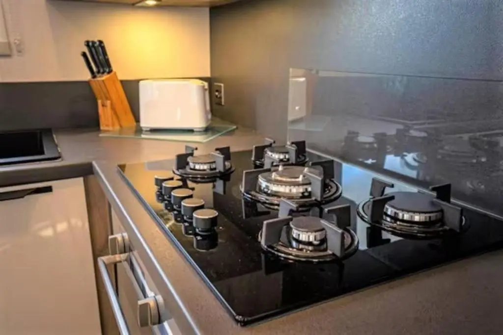 a kitchen stove with four pots and pans on it at Findhorn Lodge - Peaceful - Pets - Sleeps 4 in Forres