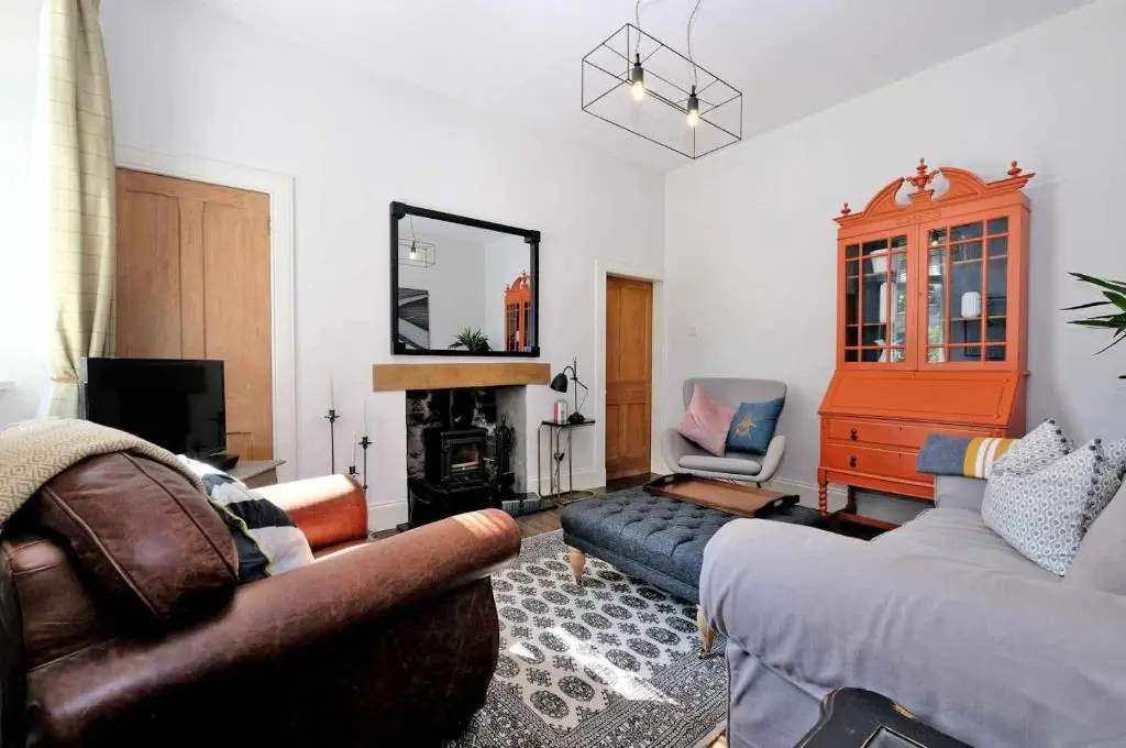 a living room with a couch and a fireplace at West Manse in Inverurie