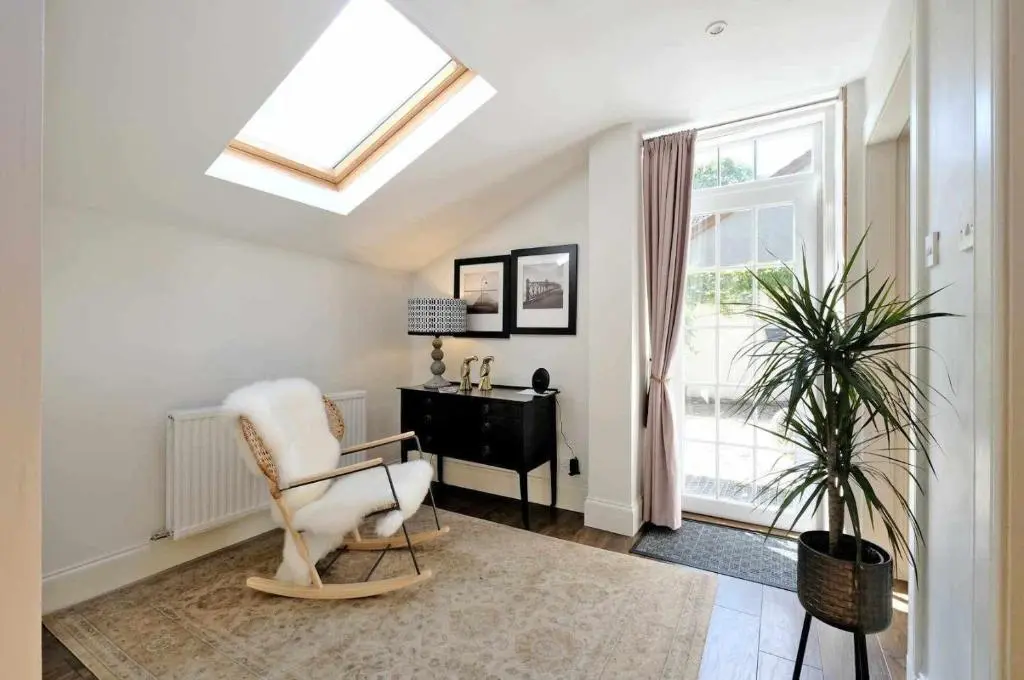 a room with a chair and a desk and a window at West Manse in Inverurie