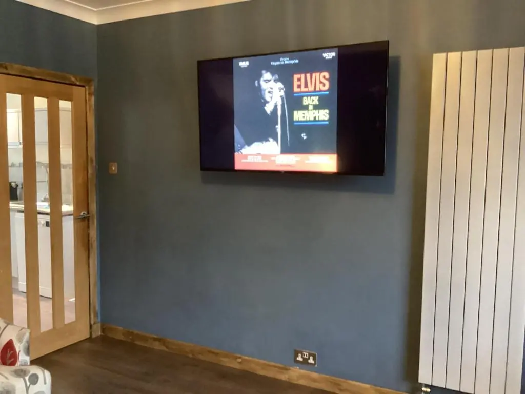 a television on a wall in a room at Charlies in Huntly