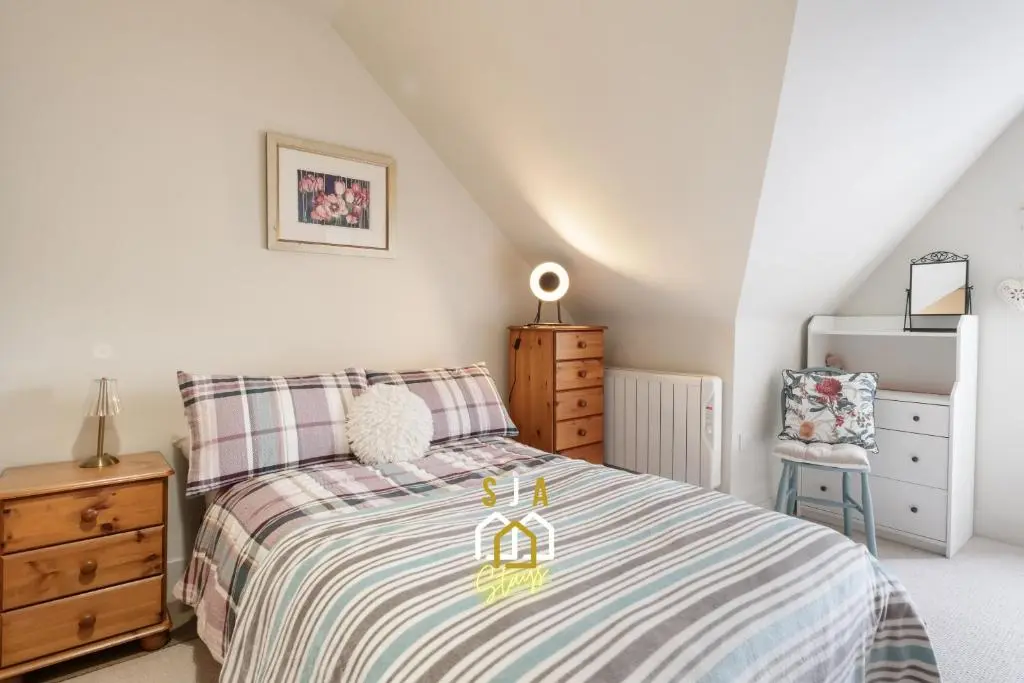 a bedroom with a bed and a wooden dresser at Ballater Retreat - SJA Stays - Modern 1 Bed Apartment in Ballater
