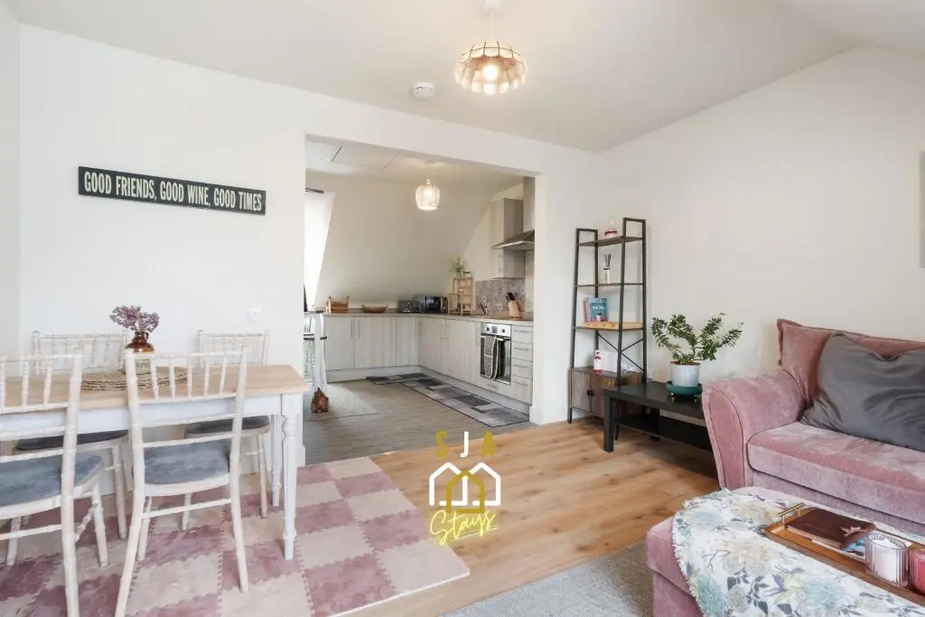 a living room with a table and a dining room at Ballater Retreat - SJA Stays - Modern 1 Bed Apartment in Ballater