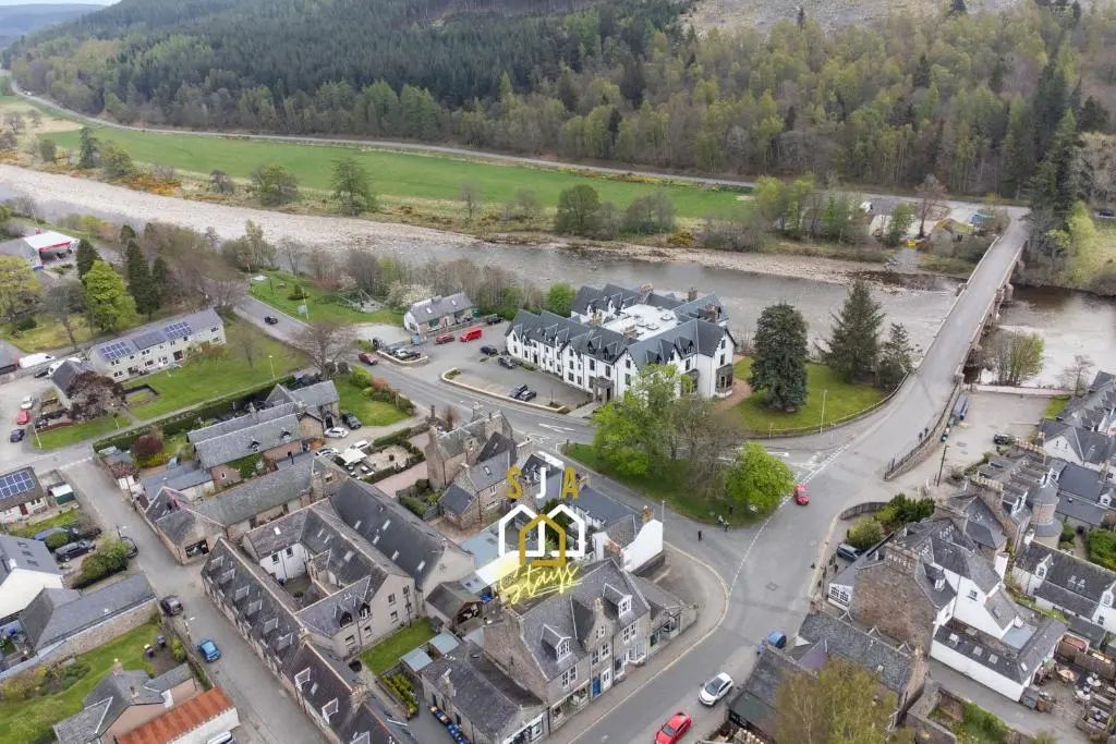 an aerial view of a town with a river at Ballater Retreat - SJA Stays - Modern 1 Bed Apartment in Ballater