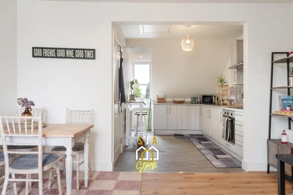 a kitchen with a table and a dining room at Ballater Retreat - SJA Stays - Modern 1 Bed Apartment in Ballater