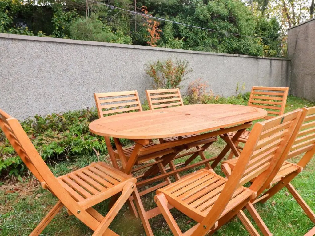 a wooden table and four chairs around a wooden table at Evansford in Ballater