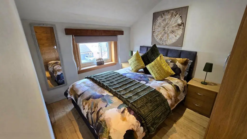 a bedroom with a bed and a window at Stylish 1-Bed City Centre Flat in Inverness