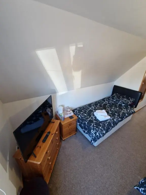 an overhead view of a bedroom with a bed and a tv at The harbour inn in Burghead