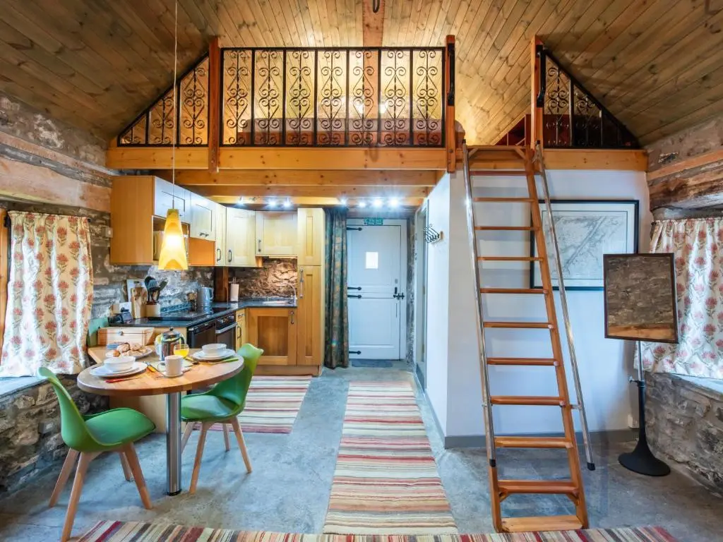 a room with a loft bed in a tiny house at Holiday Home Farmburn Bothy by Interhome in Invermoriston