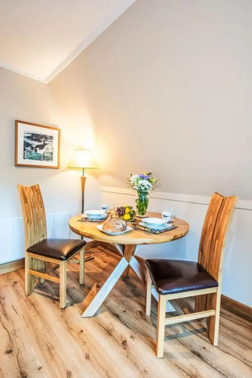 a dining room with a table and two chairs at Chalet Oystercatcher by Interhome in Spean Bridge