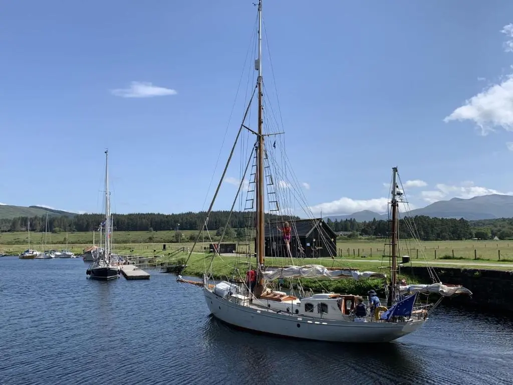 a boat is docked in a river with other boats at Chalet Oystercatcher by Interhome in Spean Bridge