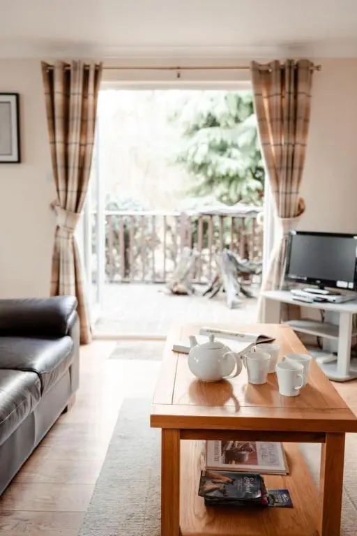 a living room with a couch and a coffee table at Chalet Lodge 7 by Interhome in Boat of Garten