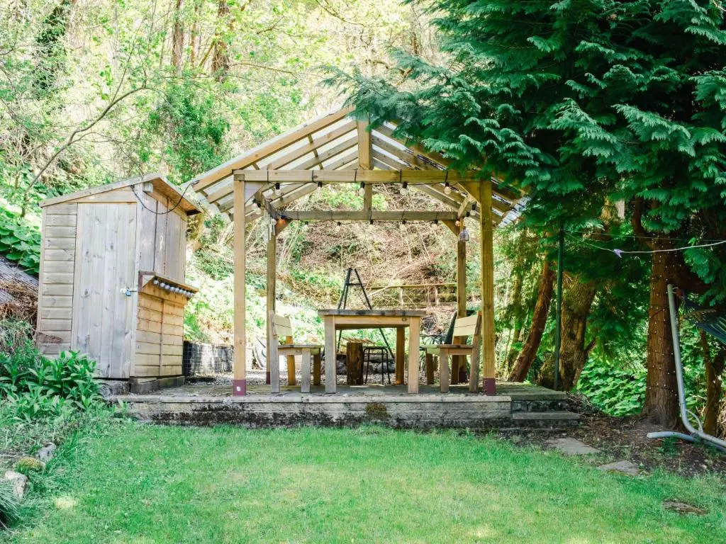 a wooden pavilion in the middle of a yard at Apartment Wayside Loft by Interhome in Drumnadrochit