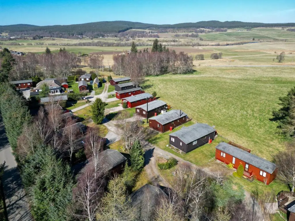 an aerial view of a farm with red buildings at Chalet Lodge 3 by Interhome in Boat of Garten
