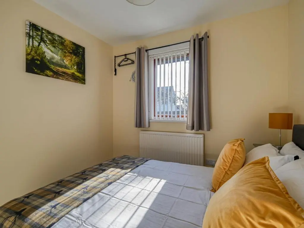 a bedroom with a bed and a window at Holiday Home Appletree by Interhome in Muir of Ord