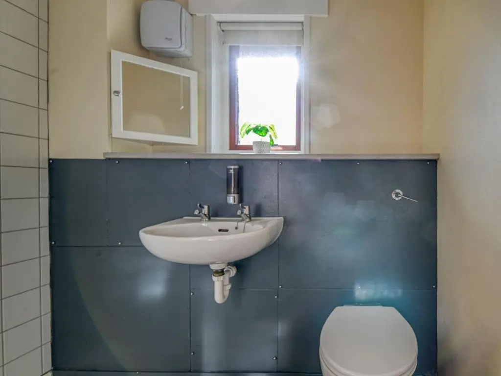 a bathroom with a sink and a toilet and a window at Holiday Home Appletree by Interhome in Muir of Ord