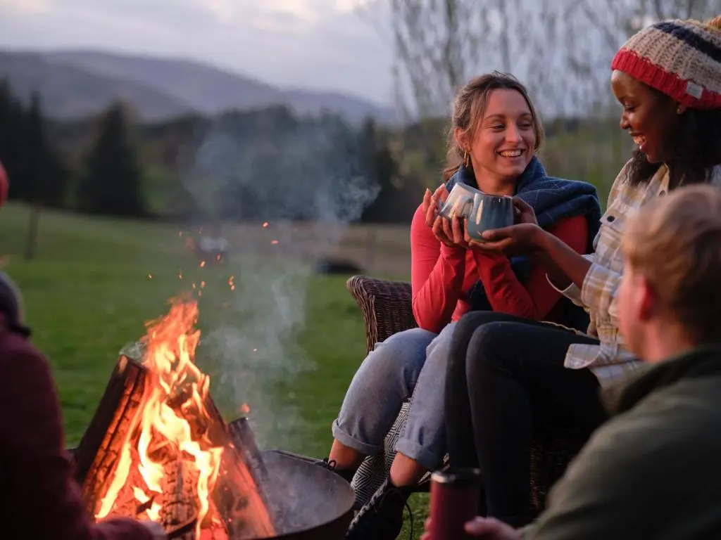 a group of people sitting around a campfire at Glenshee Glamping in Glenshee