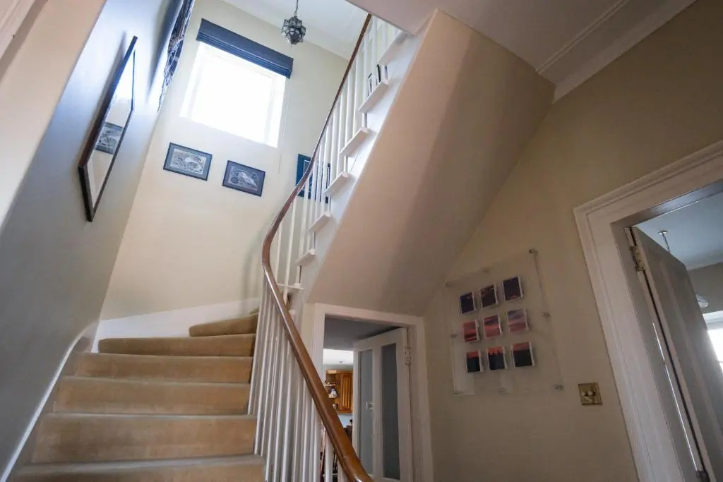 a winding staircase in a home with a window at The Old Manse Oyne in Oyne