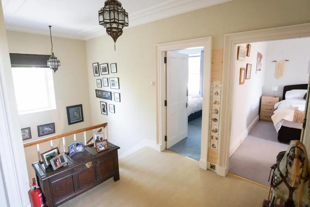 a room with a bedroom with a bed and a hallway at The Old Manse Oyne in Oyne