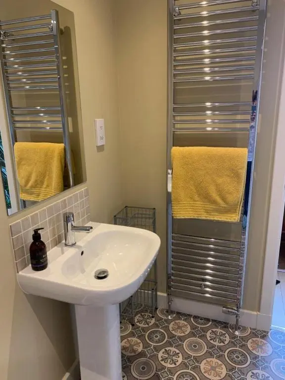 a bathroom with a sink and a shower at Loch Cottage in Boat of Garten