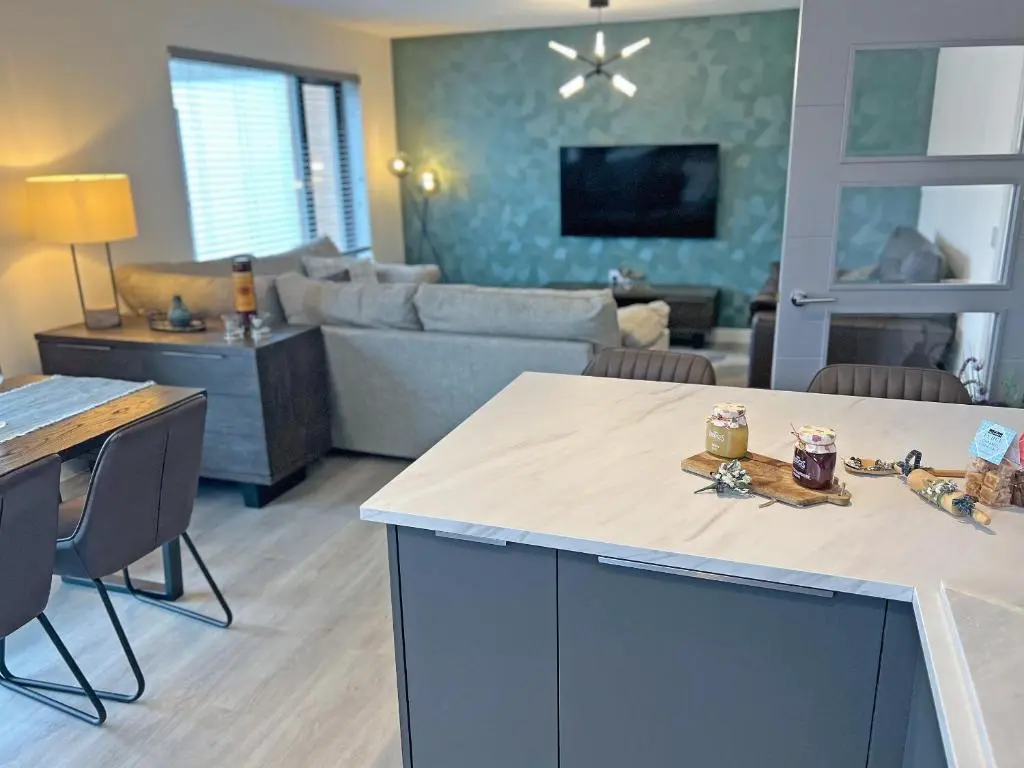 a kitchen and living room with a couch and a table at The Peaks in Aviemore