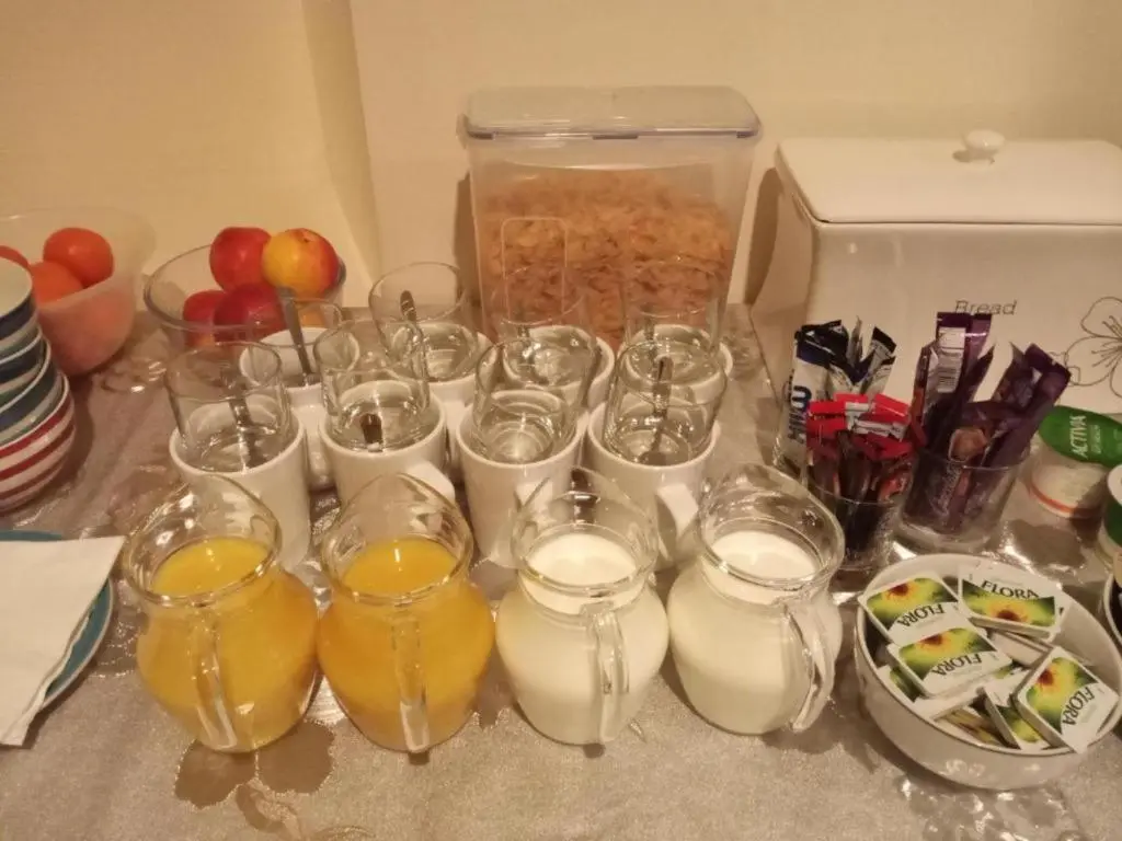 a table with glasses of milk and a box of food at Ardenlea House Hotel B&b in Dyce