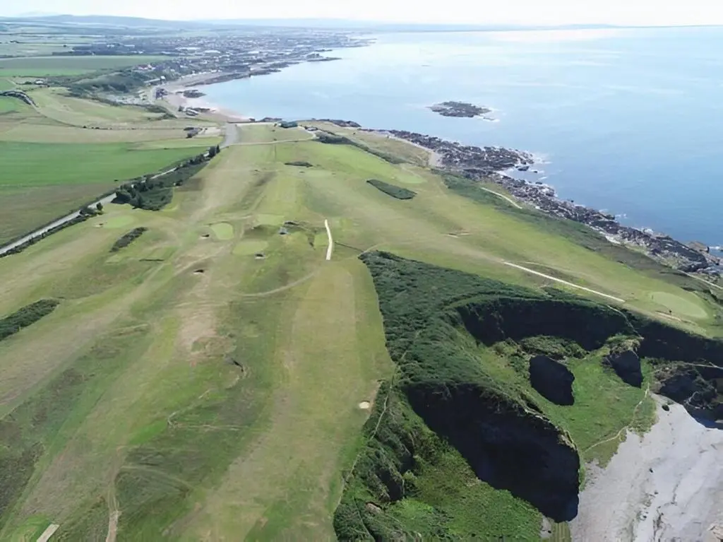 an aerial view of a golf course next to the ocean at Dalwhinnie in Buckie