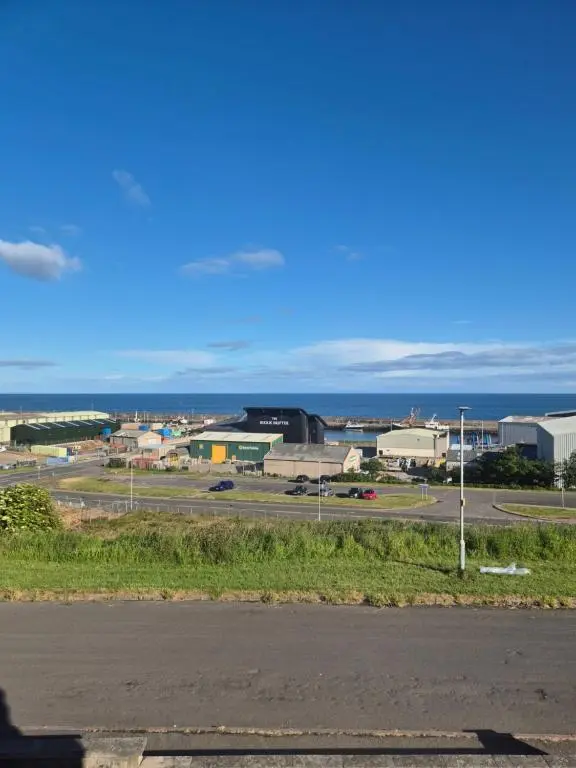 a view of a city with the ocean in the background at Dalwhinnie in Buckie
