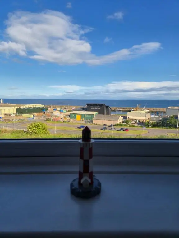 a small toy figurine sitting on a window sill at Dalwhinnie in Buckie