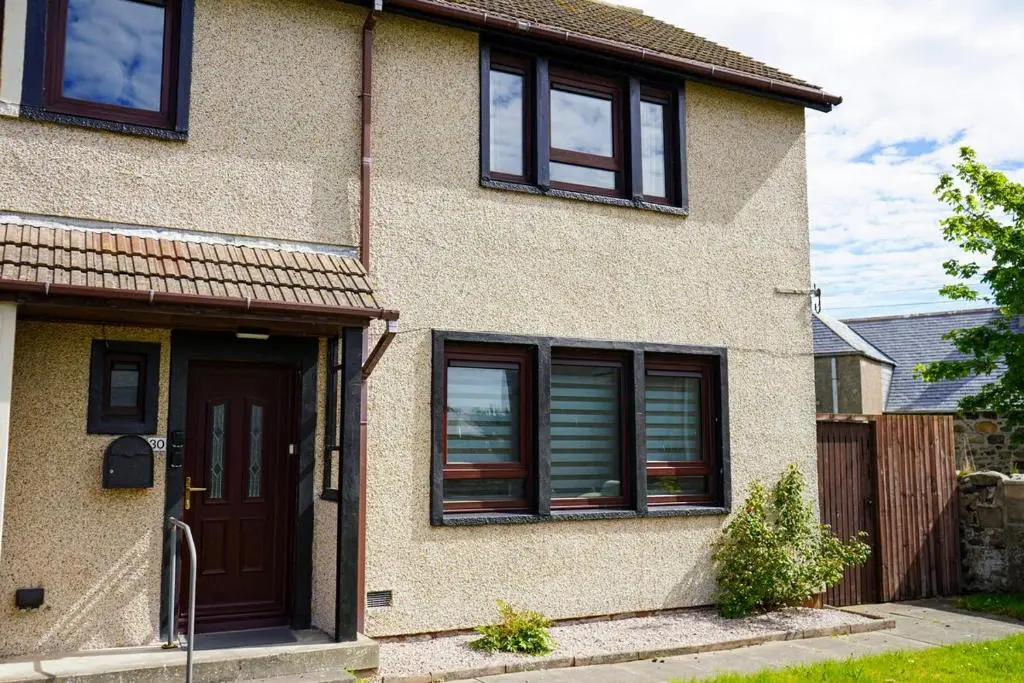 a house with a brown door and windows at Rosehearty house - 3 bedroom in Rosehearty