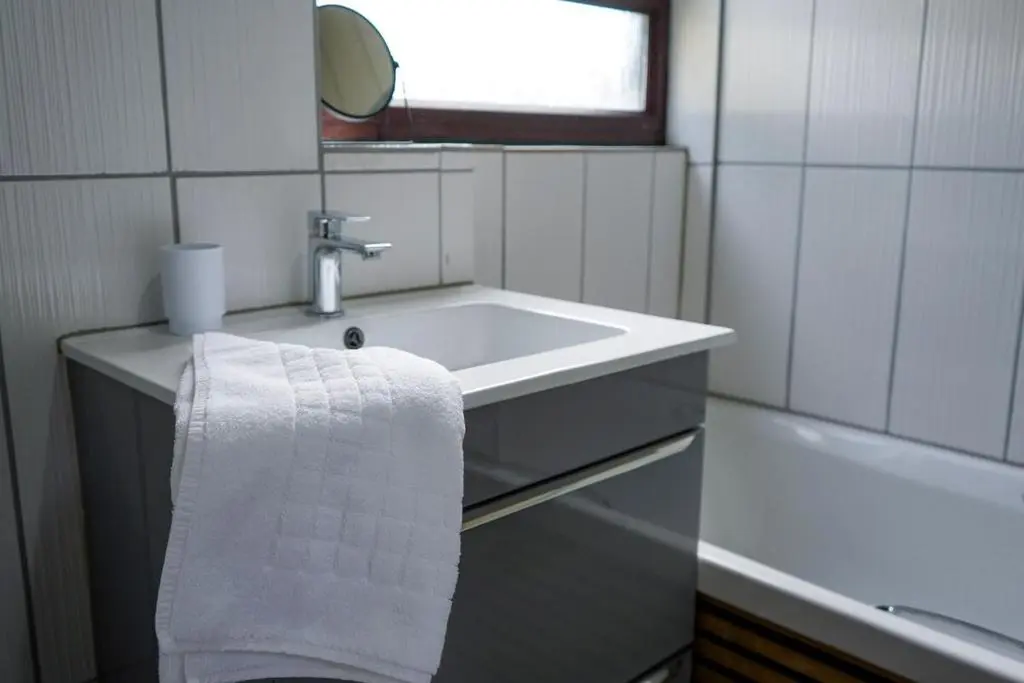 a white bathroom with a sink and a mirror at Rosehearty house - 3 bedroom in Rosehearty