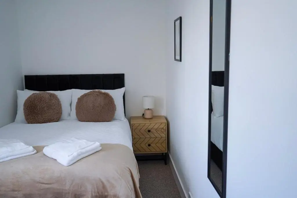 a bedroom with a bed with two towels on it at Park House - 3 bedroom in Portsoy