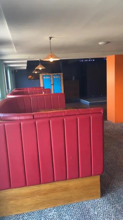 a group of red chairs in a room at Biggerstaffs retreat in Lossiemouth