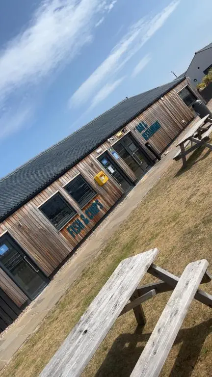 a picnic bench in front of a building at Biggerstaffs retreat in Lossiemouth