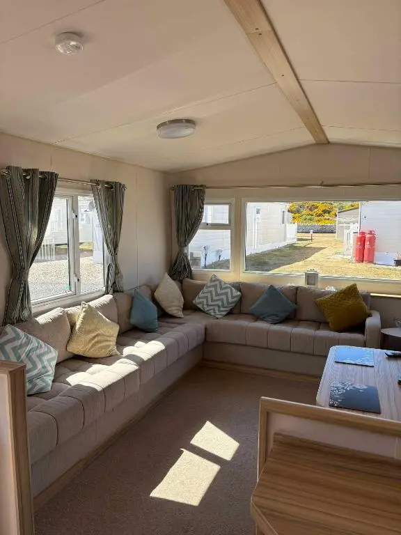 a living room with a couch with pillows on it at Biggerstaffs retreat in Lossiemouth