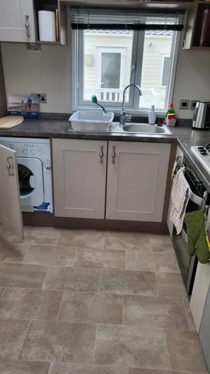 a kitchen with a sink and a stove at Northern Light Villa, forest, beach and bubbles in Burghead
