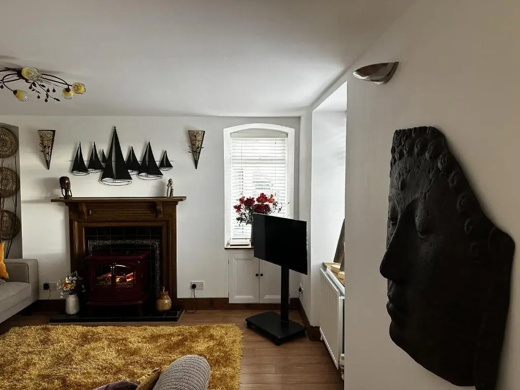a living room with a fireplace and a tv at Sealladh Sona in Inverness
