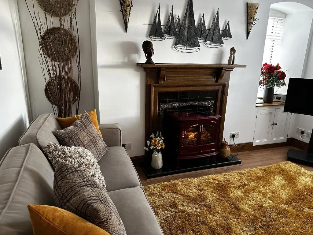 a living room with a couch and a fireplace at Sealladh Sona in Inverness
