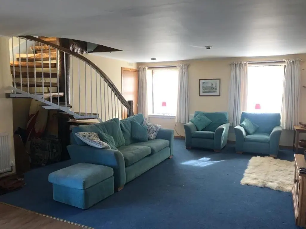 a living room with a couch and two chairs at Idyllic beach cottage 56 Seatown Cullen in Cullen