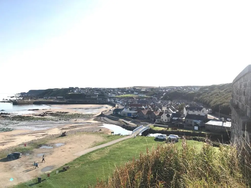 a view of a beach with houses and a town at Idyllic beach cottage 56 Seatown Cullen in Cullen