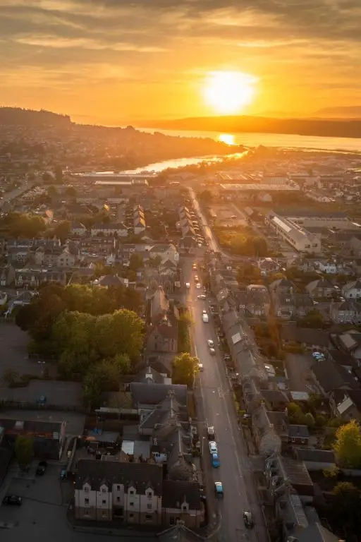 an aerial view of a city at sunset at Laughlin House in Inverness