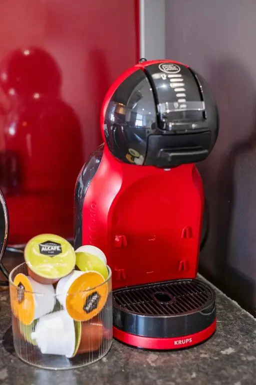 a red coffee maker sitting on a counter next to a juicer at Caledonian Buildings 20b stylish city centre apartment in Inverness