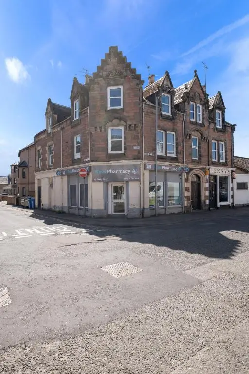 a large brick building on the side of a street at Caledonian Buildings 20b stylish city centre apartment in Inverness